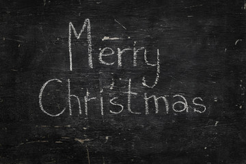 Chalk on black board: Merry Christmas