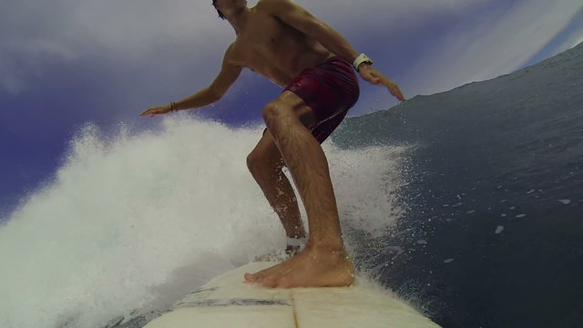 POV Surfer Riding Blue Wave