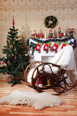 Christmas tree, fireplace and rocking-chair in interior