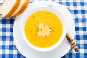 Pumpkin soup in white bowl