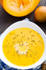 Pumpkin soup in white bowl