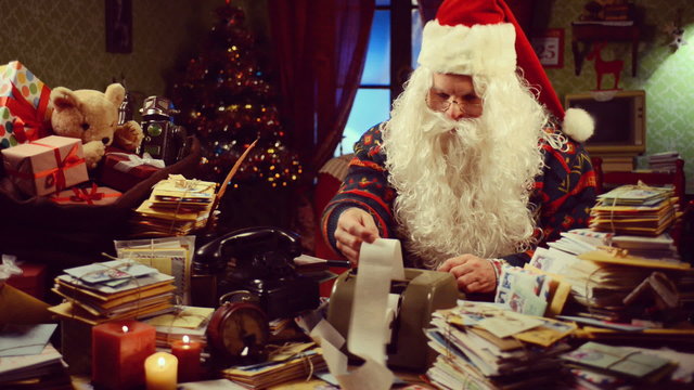 Santa Claus looking at receipts and bills