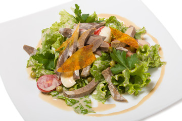 Warm salad with beef tongue, with quail eggs