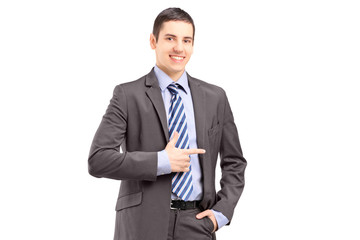 Young businessman standing and pointing