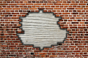 brick wall with hole and wooden board