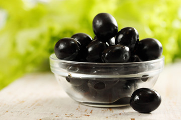 Black olives in a bowl transparent