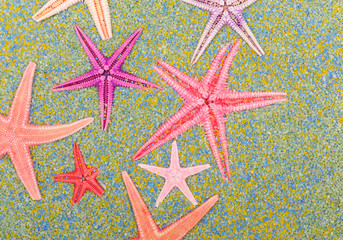Sea stars on colorful sand