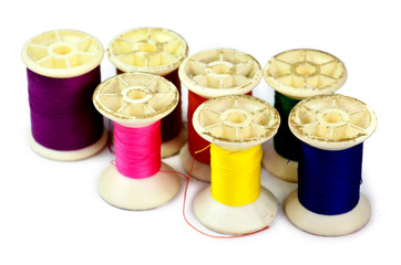 bobbins of lurex thread on white background
