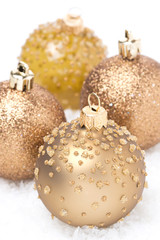 Beautiful golden Christmas balls in the snow