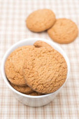 delicious oatmeal cookies in a bowl, top view
