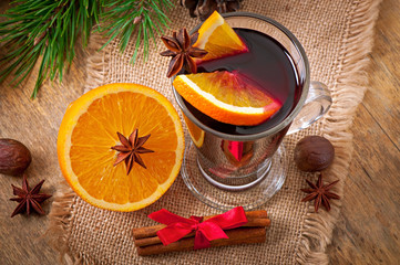 Christmas mulled wine in glass cup on a wooden table