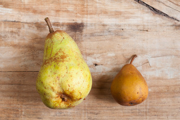 two green pear on old wooden background