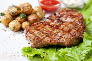 Grilled steak on a white plate