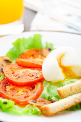 Light breakfast with soft egg, tomato and croutons