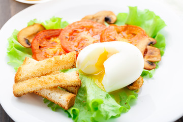 Light breakfast with soft egg, tomato and croutons