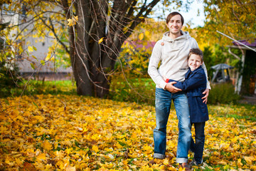 Father and son outdoors at autumn day