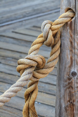 Fototapeta na wymiar Rope and knot attached to wooden pole