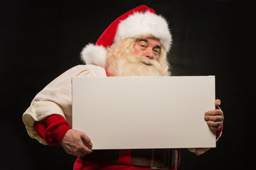 Santa Claus holding white blank sign