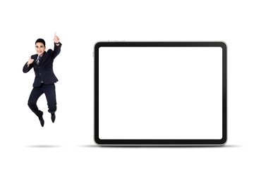 Excited businessman jumping with empty billboard