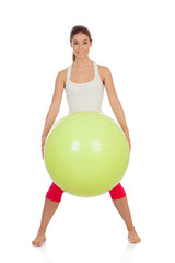 Attractive woman doing pilates with a big green ball
