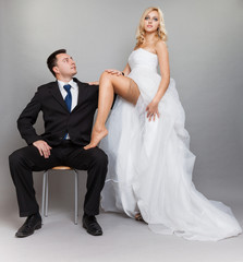 Happy married couple bride groom on gray background
