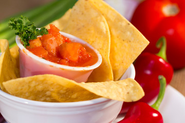 Red tomato salsa with corn chips.
