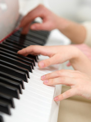 Fototapeta na wymiar Close up of hands playing piano