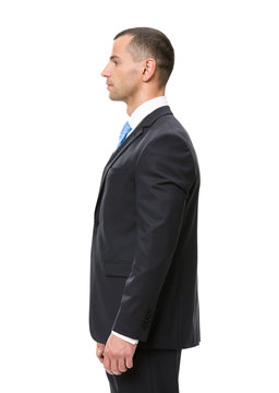 Profile of businessman wearing black suit and blue tie