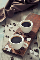 Coffee in cups with coffee beans