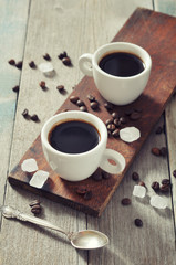 Coffee in cups with coffee beans
