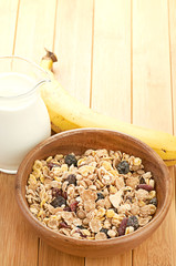 Plate with raw oatmeal on wooden table.