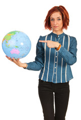 Business woman pointing to world globe