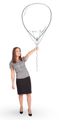 Pretty woman holding balloon drawing