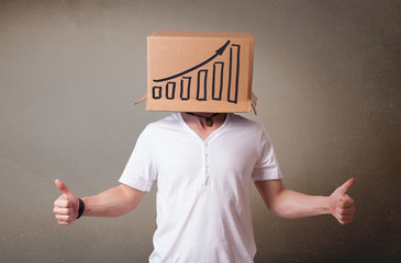 Young man gesturing with a cardboard box on his head with diagra