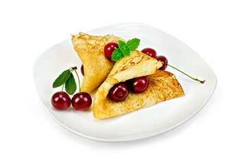 Pancakes with cherries on a plate