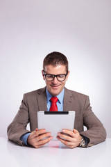 young business man reading from tablet