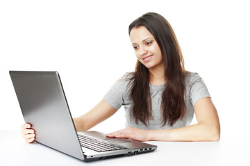 pretty young brunette woman with laptop at table