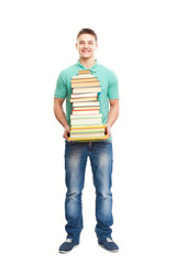 Smiling student holding big stack of books