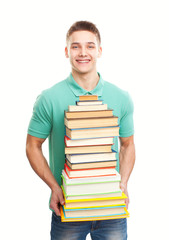 Smiling student holding big stack of books