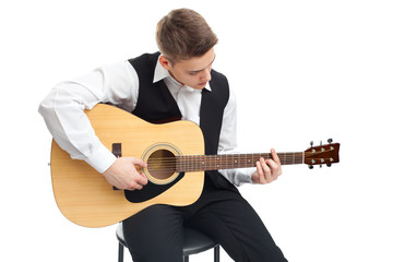 Young man playing on guitar