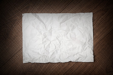 crumpled paper on wooden background