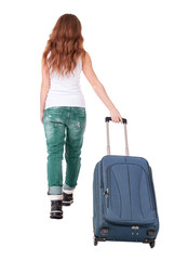 back view of walking  woman  with suitcase