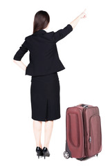 Back view of young brunette business woman traveling with suitca