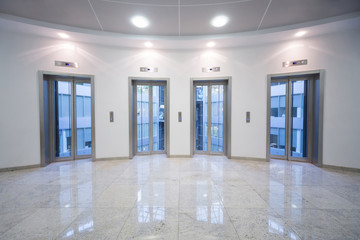 Four transparent elevator door in business center