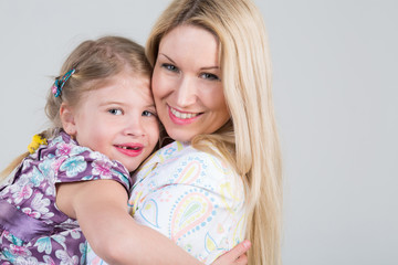 Tender portrait of mother and daughter hugging