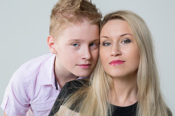 Closeup portrait of a mother and son in the studio