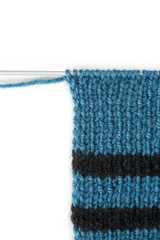 striped scarf on knitting needles