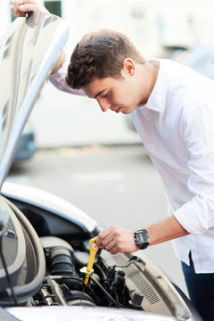 Man Checking Oil Level In Car