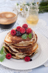 Pancakes with berries and coffee