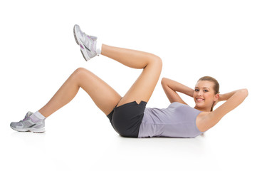 Obraz premium Athletic woman doing exercise to keep her body in shape.